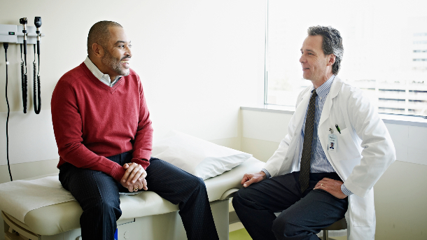 Male patient talking with doctor